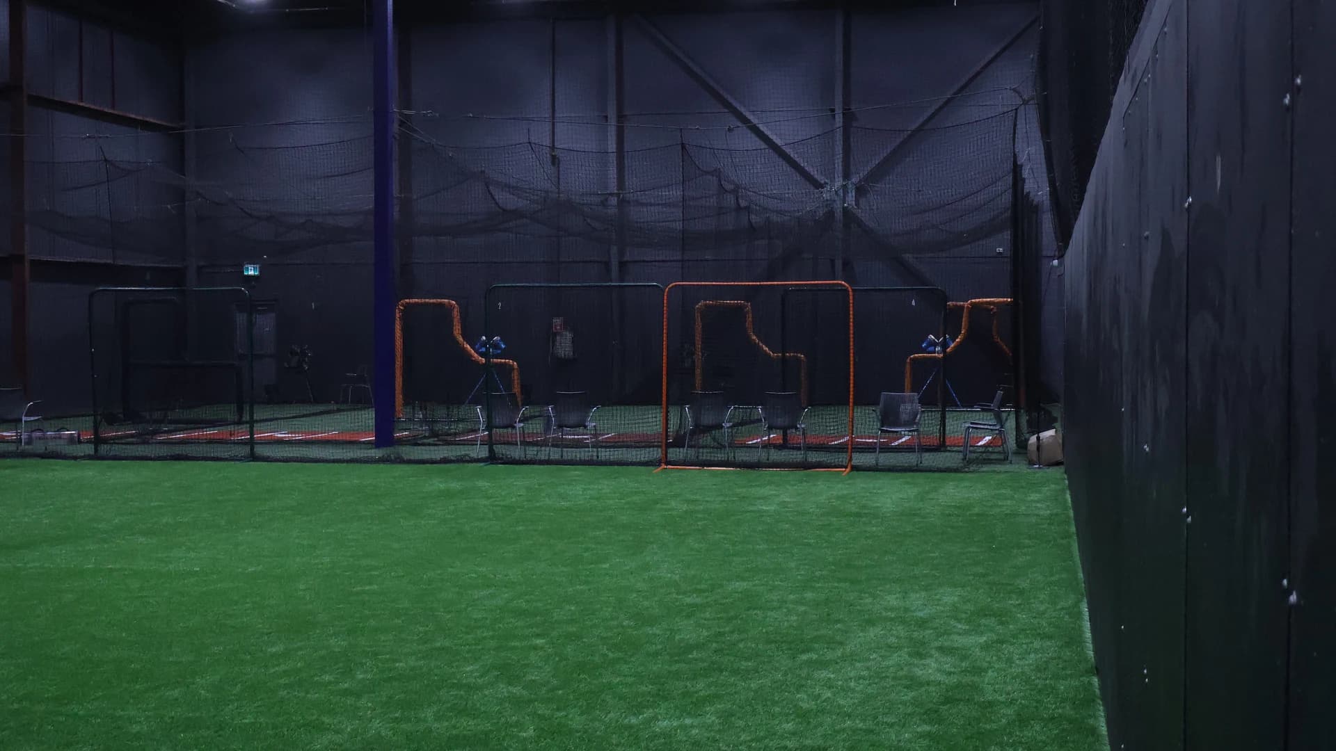 Indoor turf leading toward the batting cages